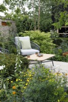 Seating area surrounded by wildlife friendly planting in The RSPCA Garden - Designer: Martyn Wilson - Sponsor: Project Giving Back -