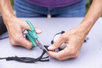 Woman cutting excess string off beneath the knot