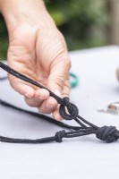 Woman tying string together to make a net