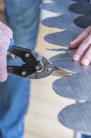 Step-by-Step Making a Plant Theatre. Step 21: using a pair of tin snips, cut the scalloped edge along the lead flashing, apart from a central 20mm wide flap which allows for the scalloping to overlap tidily when the lead is fitted over the 90 degree angle of the roof's apex