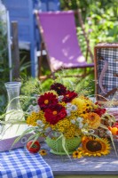 Floral arrangement with Dahlia, Rudbeckia, Tanacetum vulgare, Foeniculum vulgare, Astrantia and Hakonechloa macra.