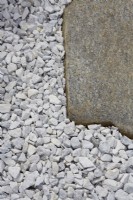 Detail of irregular stone slabs set into white gravel.
