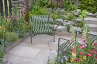 Seating area in 'Elements of Sheffield' garden at the RHS Chatsworth Flower Show 2019, June
