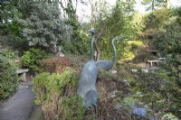 Metal sculptures of two cranes in The Japanese Garden at Compton Acres, Canford Cliffs, Dorset in March