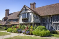 Collection of summer containers around the front porch at Great Dixter