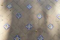 Terracotta tiles interspersed with colourful glazed tiles on a path in the Parque de Maria Luisa, Seville, Spain. September