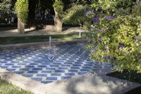 A blue and white tiled pool with two fountains. Parque de Maria Luisa, Seville, Spain. September