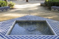 A geometric, tiled fountain in the Mudejar, Islamic style. Parque de Maria Luisa, Seville, Spain. September