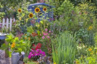 Summer flowers in the kitchen garden to attract beneficial wildlife including Sunflowers, Calendula officinalis, Dahlia, Verbena, Impatiens and Tagetes.