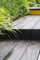 A boardwalk made from reclaimed wood with grasses planted alongside - Hurtigruten: The Relation-Ship Garden, Max Parker-Smith, RHS Hampton Court Palace Garden Festival