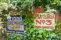 Old advertising signs as garden decoration 