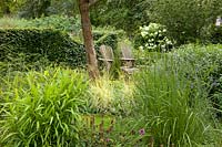 Natural garden with seating area and grasses 