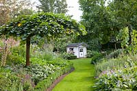 Garden view with weeping elm and playhouse 