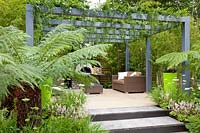 Terrace with pergola and tree ferns, golden cane bamboo, small periwinkle, Dicksonia antarctica, Phyllostachys aurea, Vinca minor Alba 