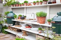 Outdoor kitchen with herb pots 