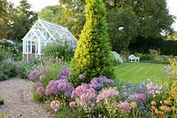 View of greenhouse, Allium christophii, Campanula lactiflora Loddon Anne 