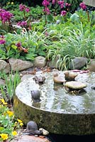Small pond with millstone 