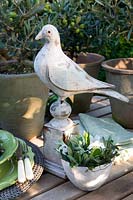 Olive branches and rose blossom in bowl as table decoration 