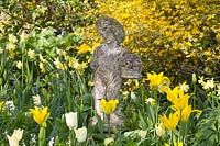 Tulips with putto in front of ranunculus bush 