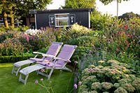 Seating area in front of garden house 