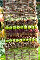 Floristry with seed heads and apples in autumn 