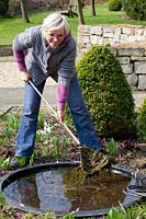 Fishing algae out of the pond 