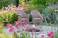 Seating area at the water feature, Echinacea Razzmatazz, Echinacea pallida, Sanguisorba, Monarda Marshall's Delight, Pennisetum orientale Karley Rose 