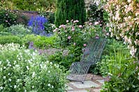 Seating in the rose garden, Rosa Mary Rose, Geranium pratense Album, Delphinium, Kolkwitzia amabilis 