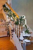 Christmas decorated staircase with garland and ice skates 