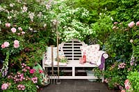 Seating area with fragrant plants, Rosa, Cornus kousa, Syringa 
