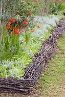 Bed edging made from woody cuttings 