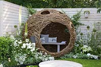 Willow arbor in a small garden with chamomile as a lawn substitute 