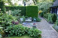 Seating area in the shade with Funkia, Hosta 