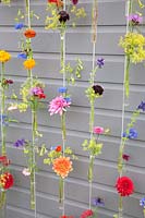 Colorful flowers in water tubes on wire ropes 