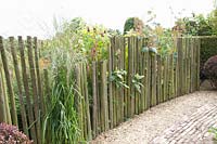 Fence made of round timbers of different heights 