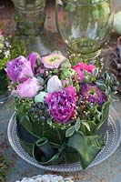 Cake-shaped arrangement with tulips and ranunculus 