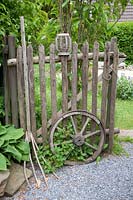 Stillife wooden fence with wagon wheel and pitchfork 