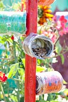 Bird feeding station made from tin cans 