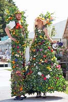 Stilt walkers at a flower show 