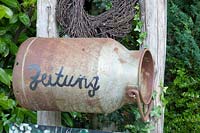 Old milk can as a newspaper box 