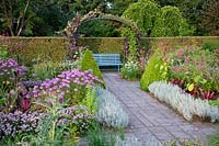 Cottage garden in late summer, Allium senescens, Helichrysum italicum; Cleome Senorita Rosalita, Persicaria orientalis; 