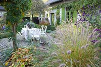 Seating area in autumn, Pennisetum alopecuroides Foxtrot, Salvia Amistad 