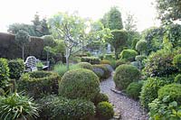 Mediterranean garden with bench and topiary 