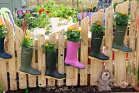 Rubber boots planted with marigolds 