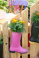 Rubber boots planted with marigolds 