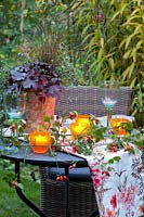 Table with lanterns in the autumn garden 