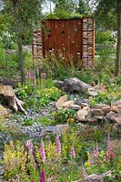 Natural garden with firewood rack made of Corten steel 