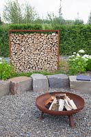 Privacy screen made of Corten steel and firewood 