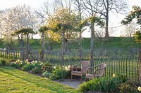 Rural spring garden with picket fence 