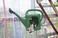 Watering can as a container for garden accessories 